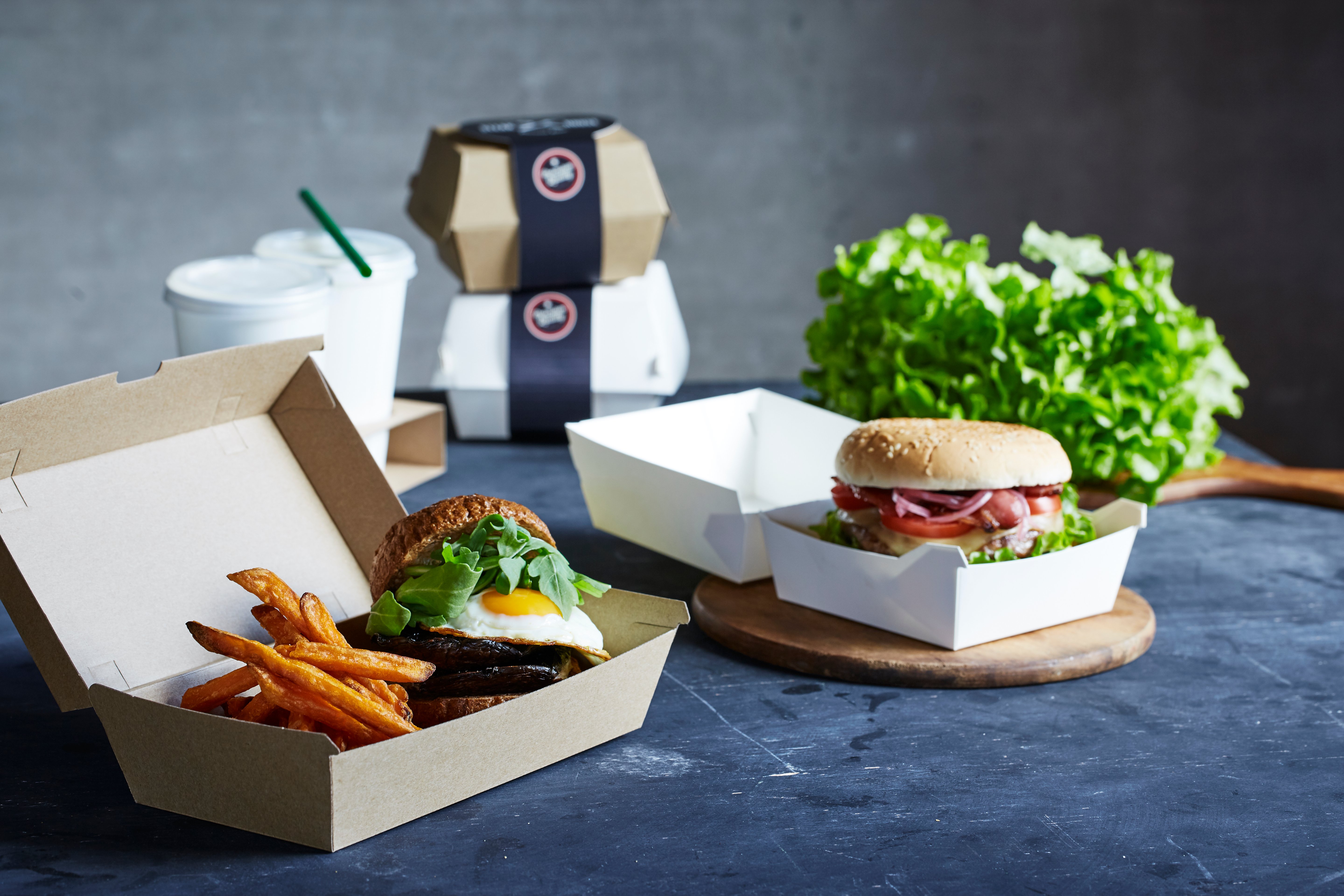 Burgers packaged in cartons for food delivery. 