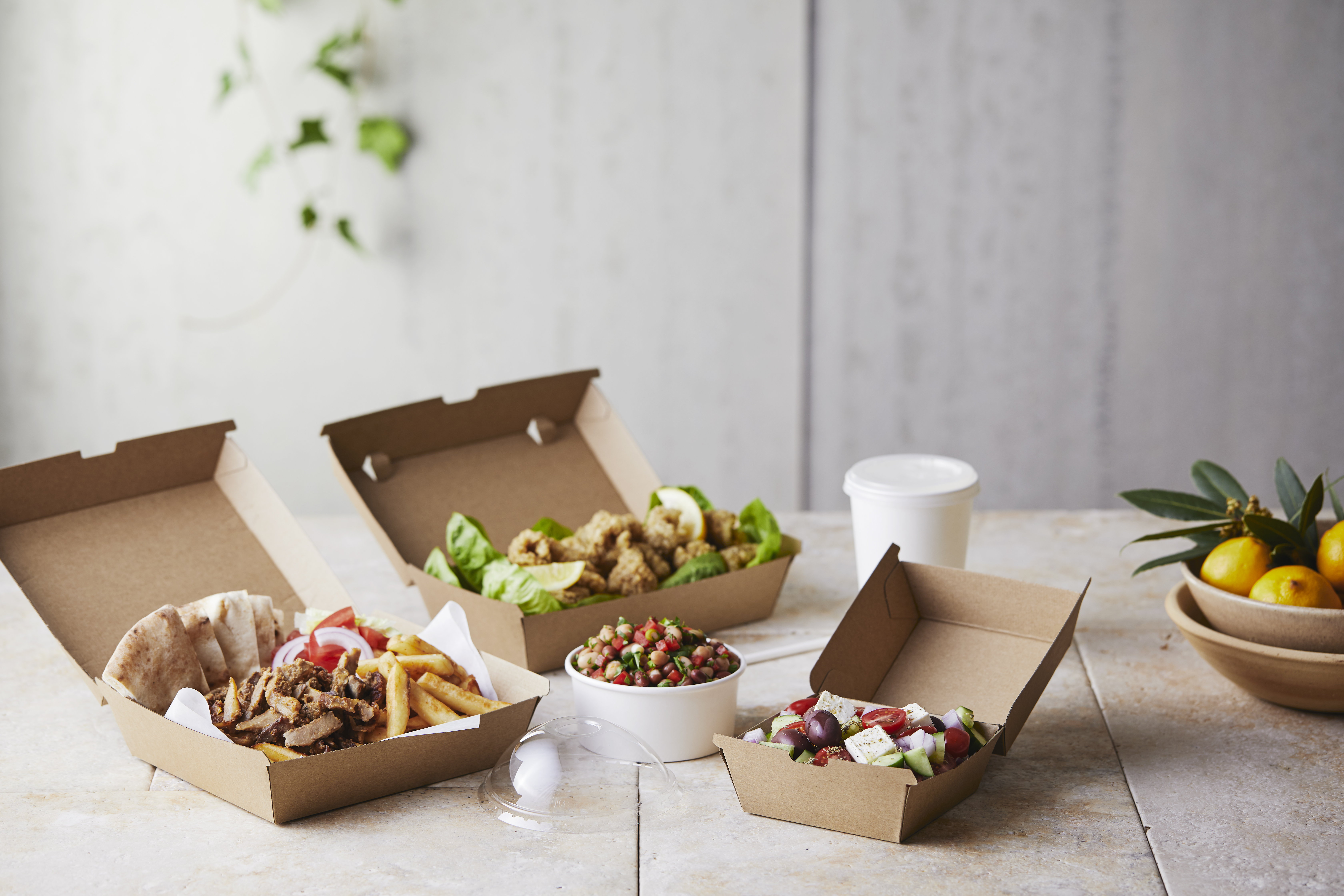 Takeaway chips, meat and salad served in kraft cartons. 