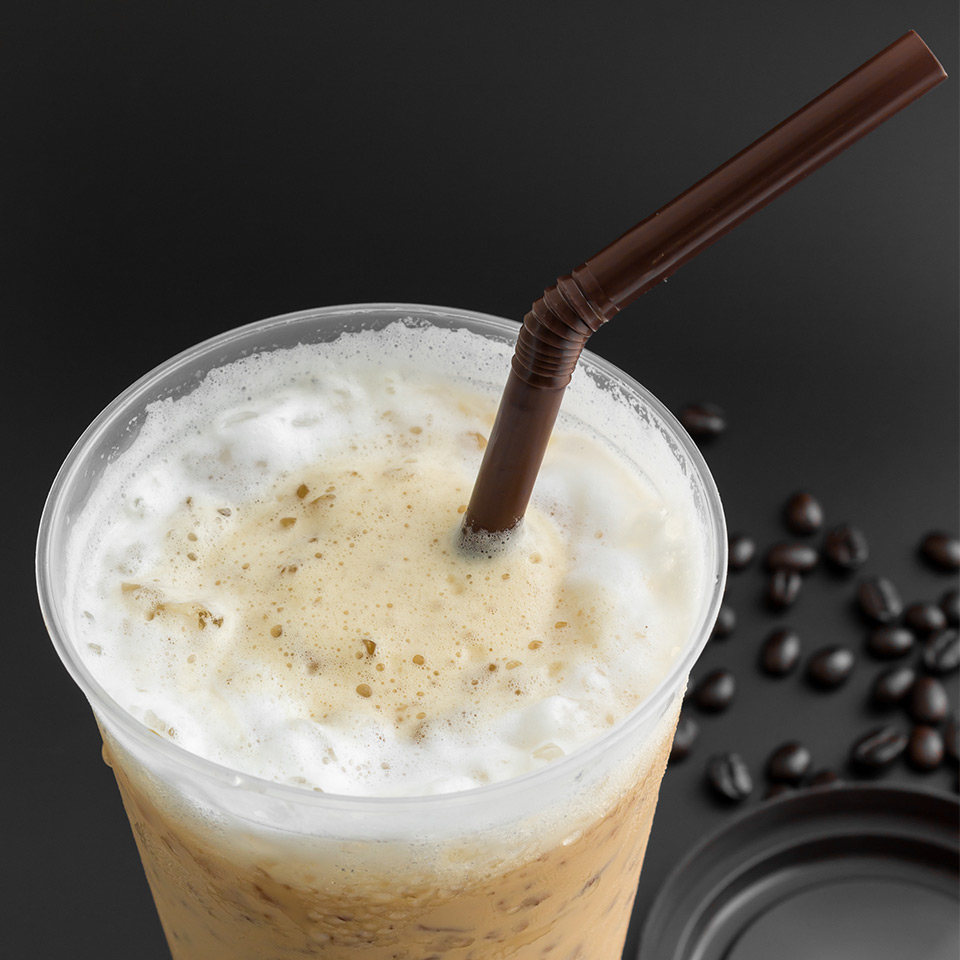 Image of plastic cup and plastic straw on dark background