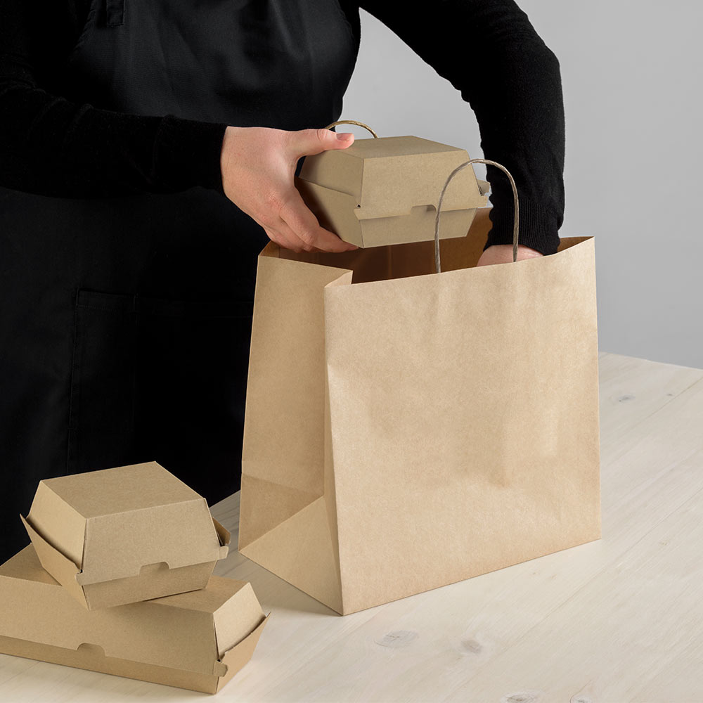 Image of food being lifted into a Detpak carry bag