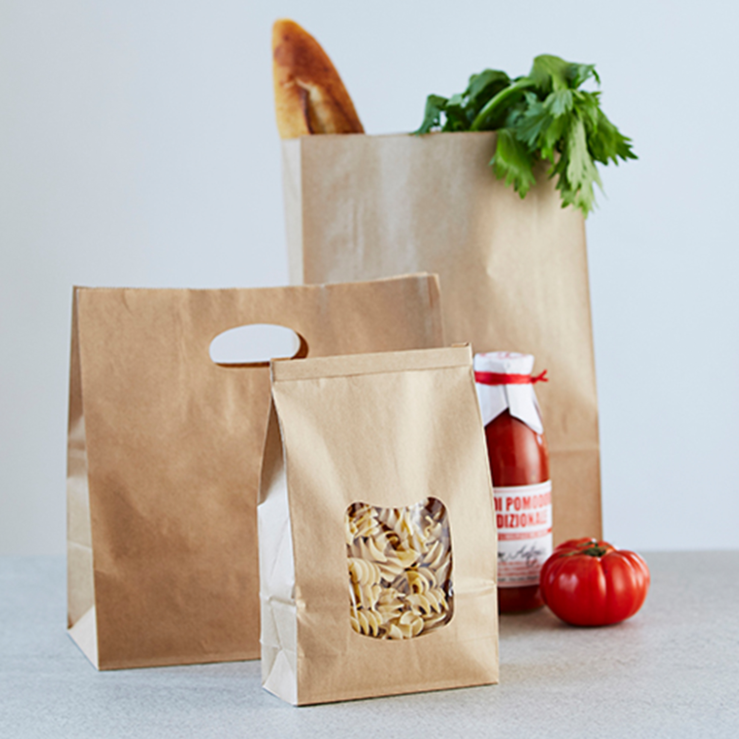 Image of three paper bags with groceries inside