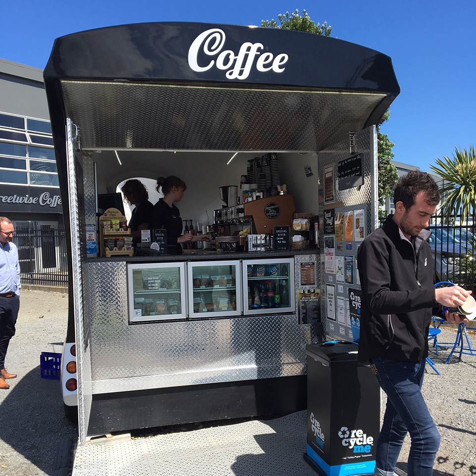 Consumer walking away from Streetwise Coffee cart with RecycleMe cup