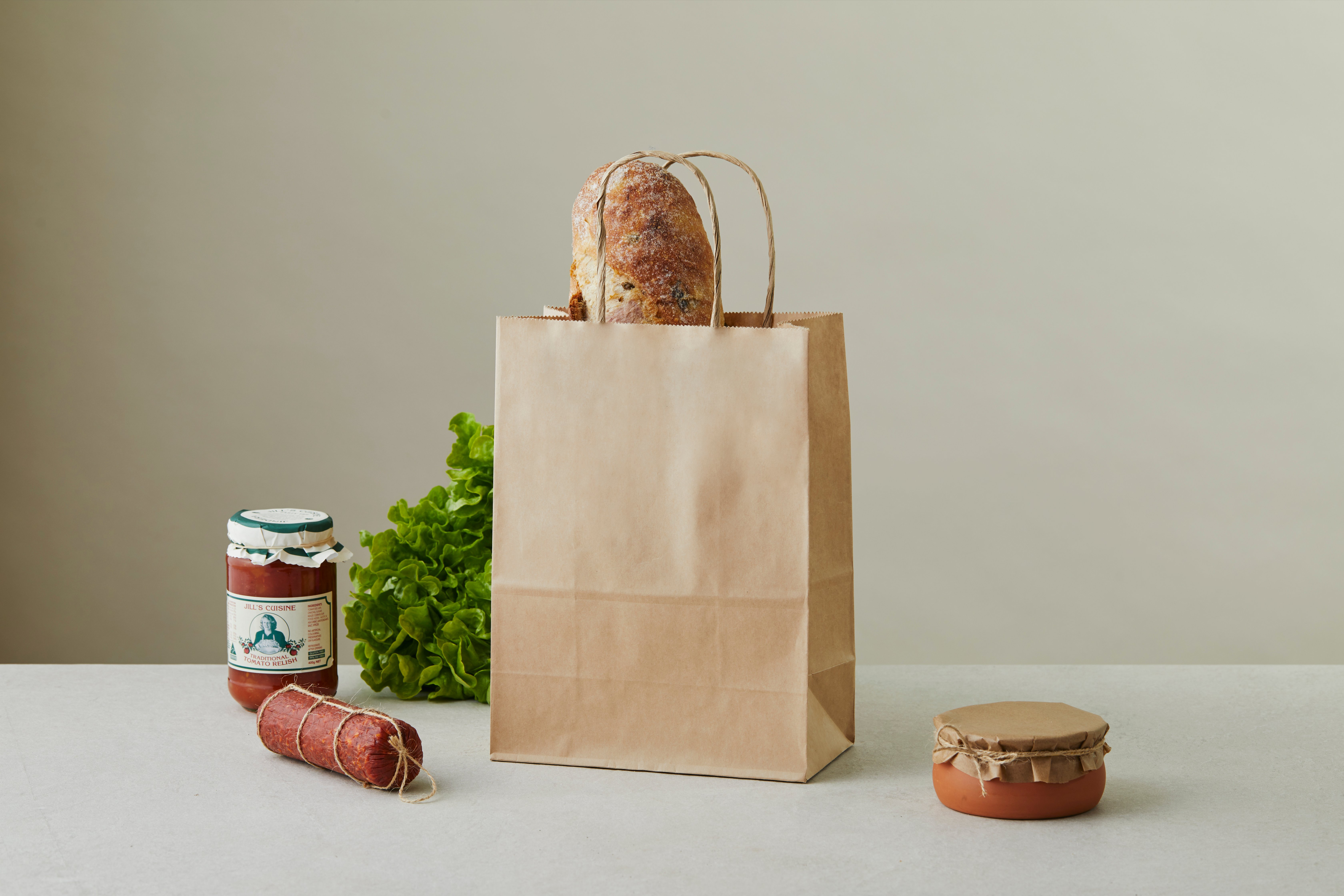 Paper bag filled with fresh bread.