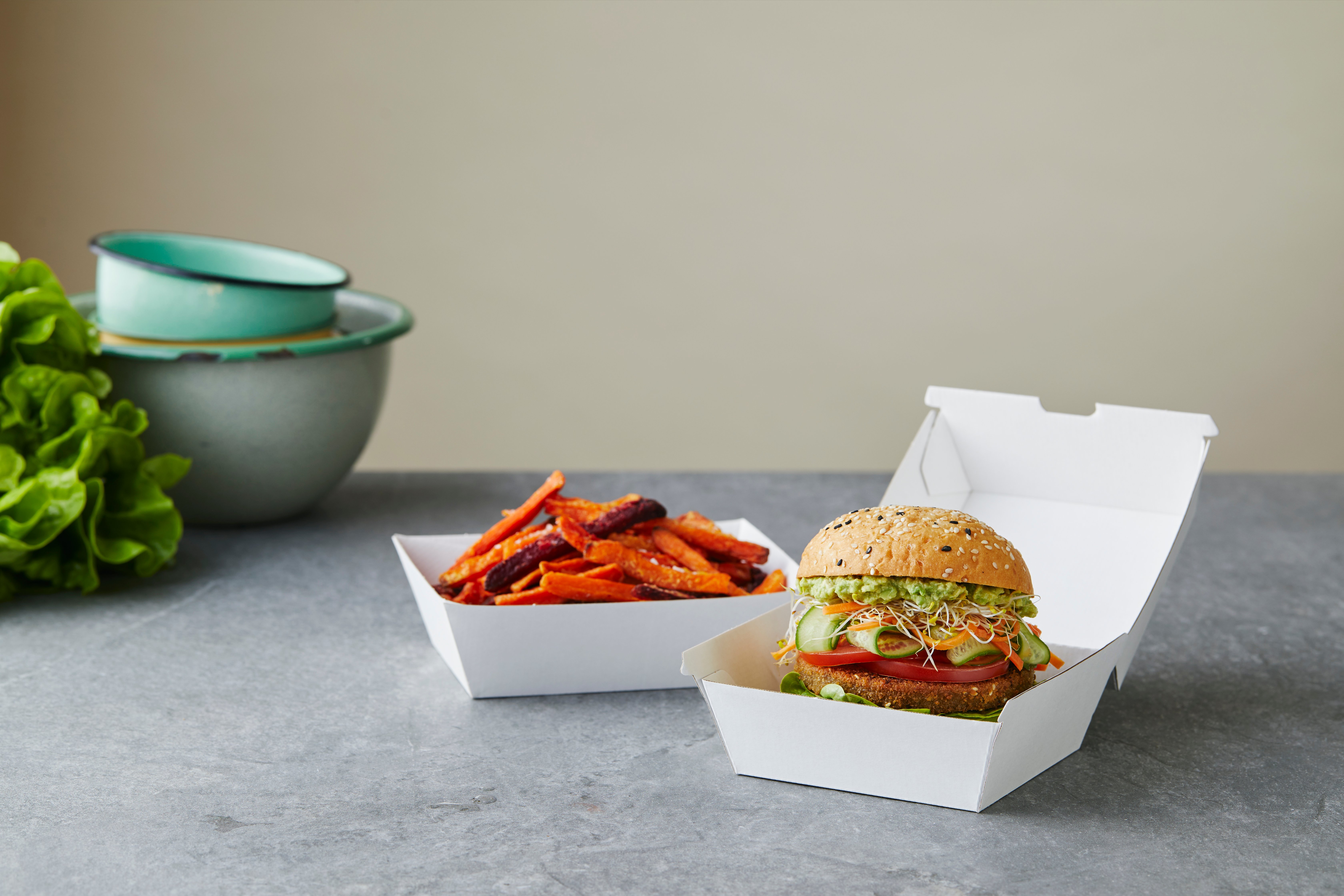 Burger and hot chip served in paper cartons. 