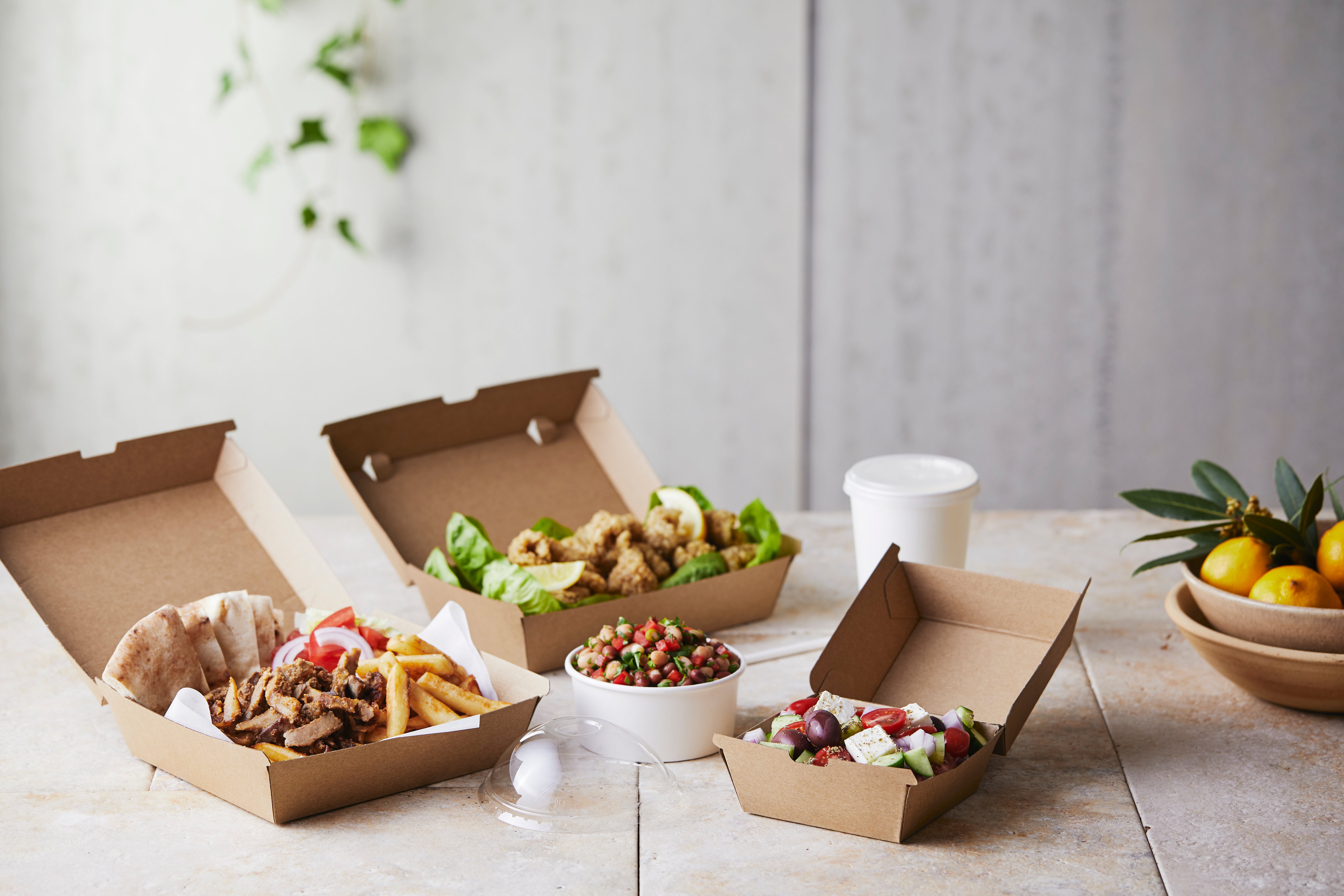 Takeaway chips, meat and salad served in kraft cartons.