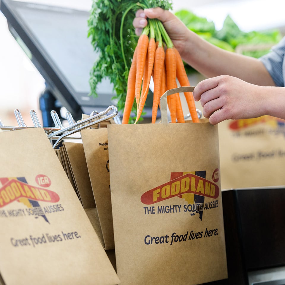 Image of Detpak paper bag being loaded with groceries at Foodland