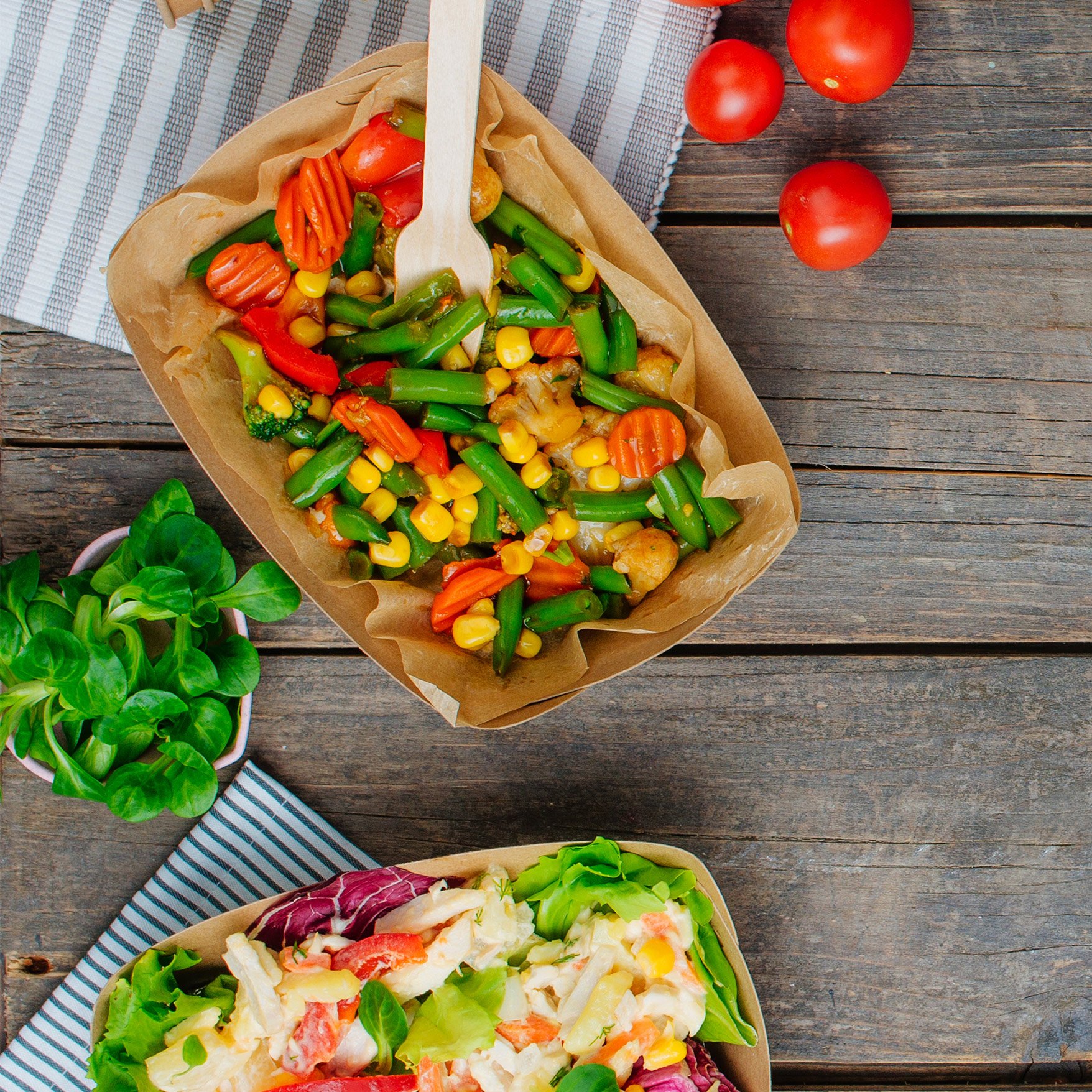 Image of wooden cutlery in a takeaway carton with food