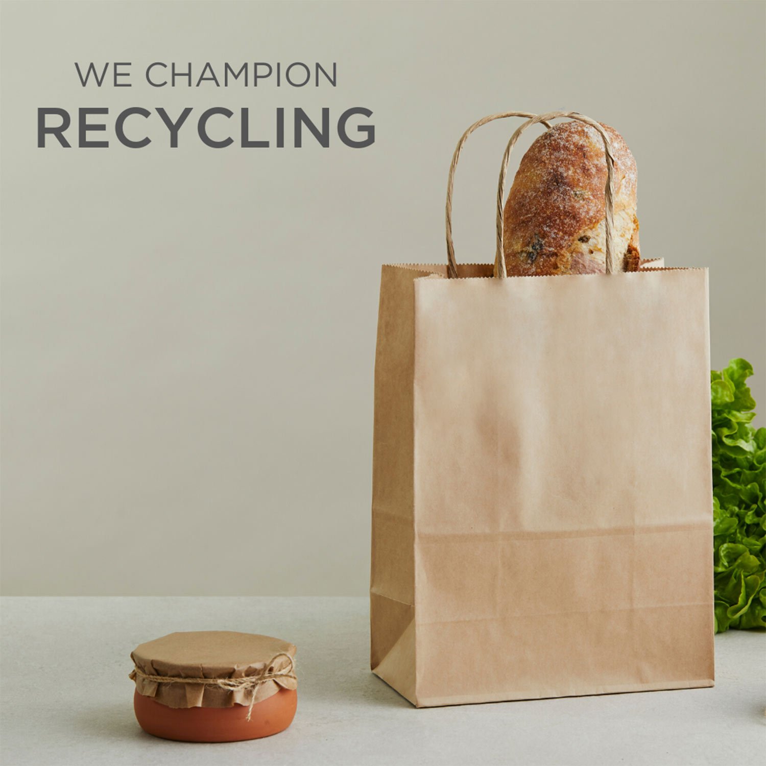 Image of paper bag with text 'We Champion Recycling'