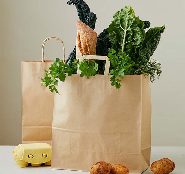 Detpak paper carry bag filled with groceries. 