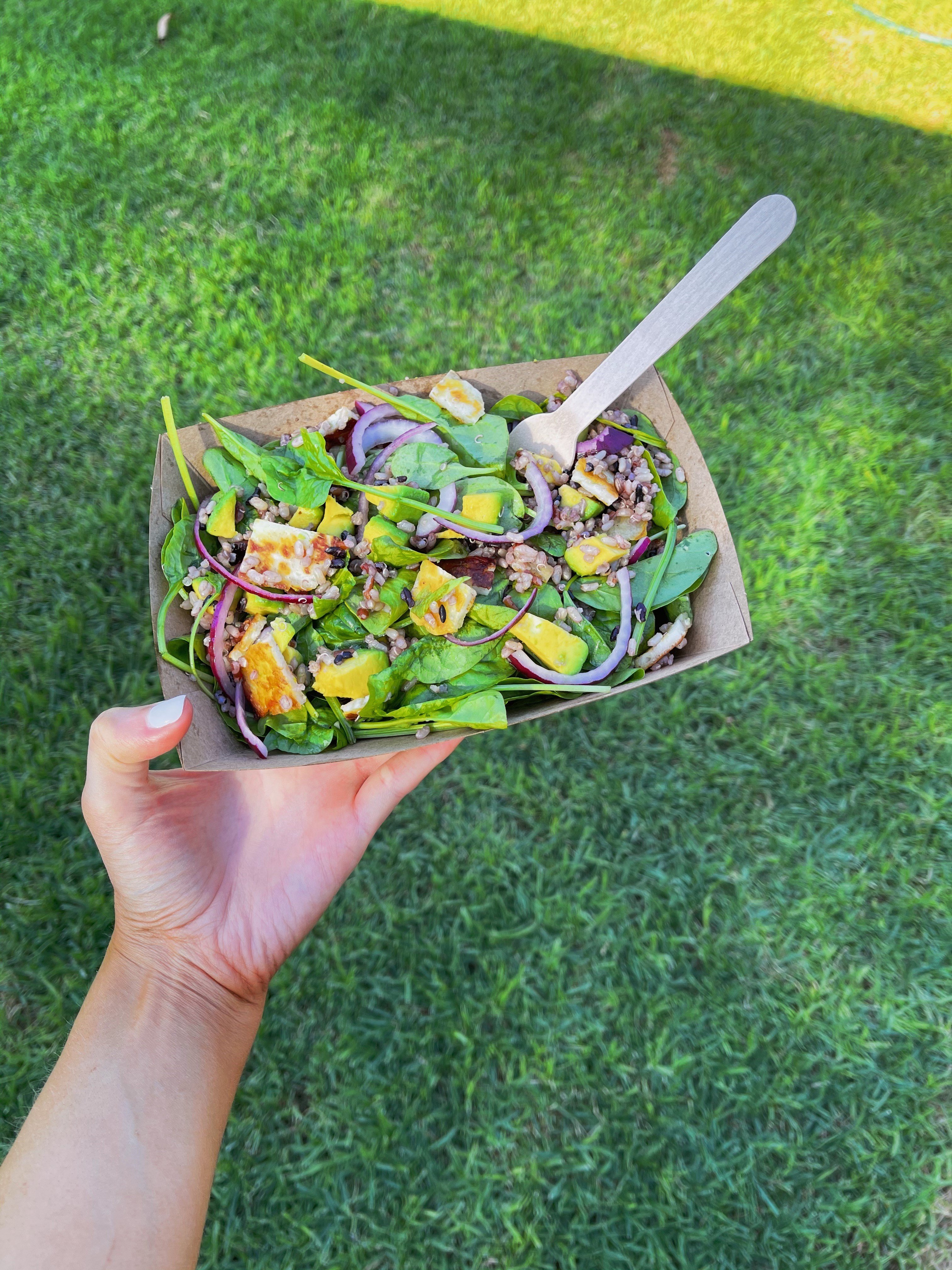 Detpak go range tray filled with salad and pictured with a fork.